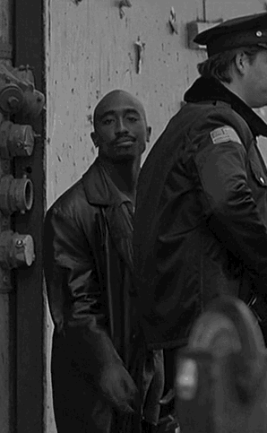 Black And White Man In Leather Jacket And Police Officer GIF