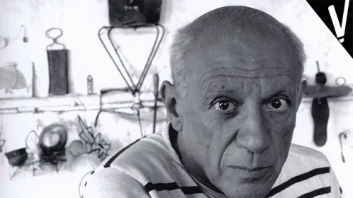 Black and White Man in Striped Shirt Looking at Camera