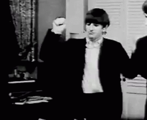 Black And White Man In Suit Raising Fist GIF