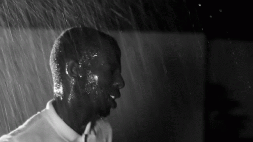 Black and White Man in White Shirt in Rain