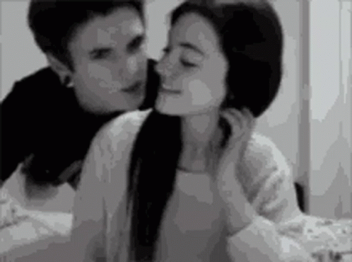 Black and White Man Kissing Woman on Forehead
