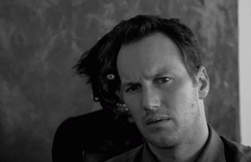 Black And White Man Looking At Camera With Monster Behind GIF