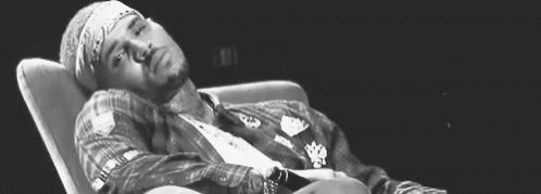 Black and White Man Lying in Chair