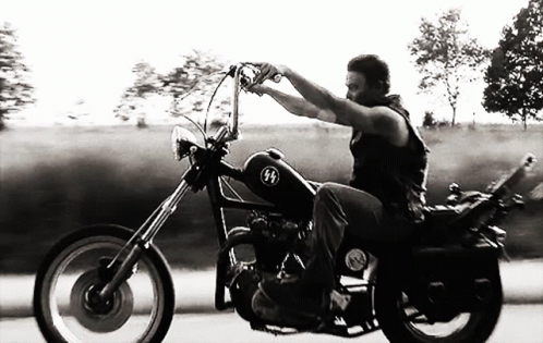 Black And White Man Riding Motorcycle With SS Logo GIF