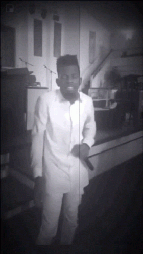 Black and White Man Singing into Microphone in Church