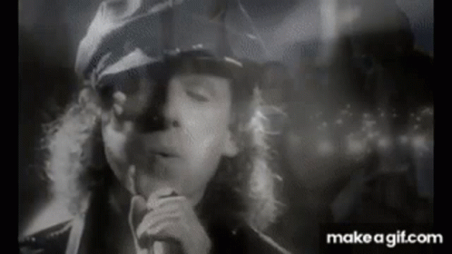 Black and White Man Singing Into Microphone Smoking