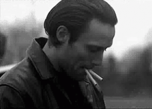 Black And White Man Smoking Cigarette In Leather Jacket GIF