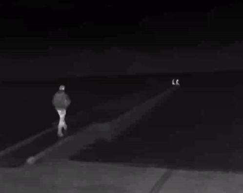 Black and White Man Standing on Dock at Night