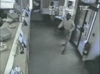 Black and White Man Walking Down Hallway With tue