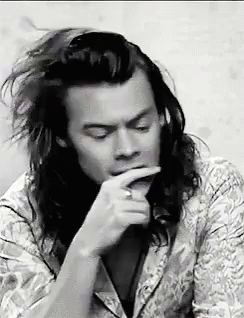 Black and White Man With Long Hair Hand to Mouth