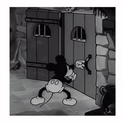 Black and White Mickey Mouse Standing Next to Door