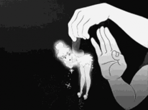 Black and White Person Holding Tinkerbell Doll