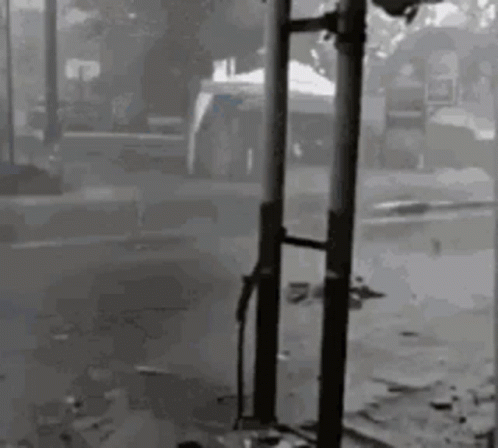 Black And White Person Next To Pole GIF