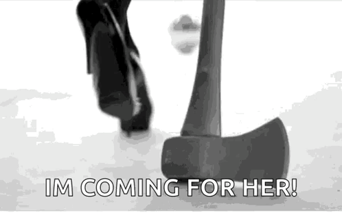 Black And White Person Standing Next To Large Axe GIF