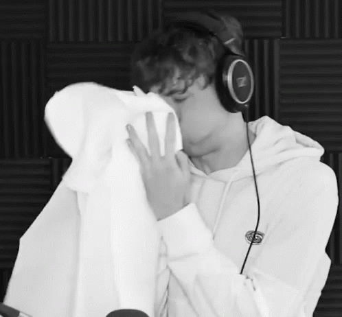 Black and White Photo Man in Headphones Kissing Another Man