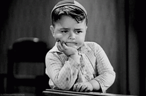 Black And White Photo Of Boy With Hand On Chin GIF