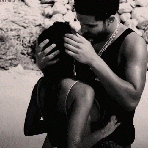 Black and White Photo of Man and Woman Hugging and Kissing