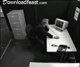 Black and White Photo of Man at Desk With downloadfeast.com