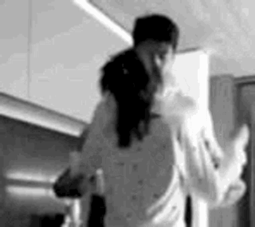 Black And White Photo Of Man Carrying Woman On Back In Kitchen GIF
