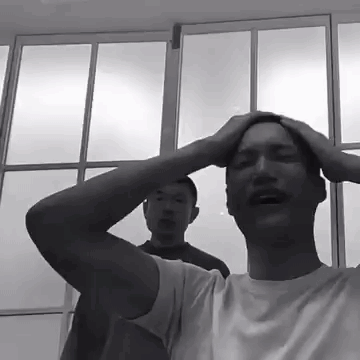 Black and White Photo of Man Holding Head