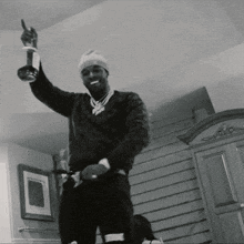 Black and White Photo of Man Holding Trophy