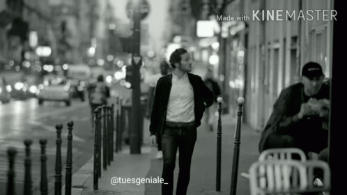 Black And White Photo Of Man Walking Down Street GIF