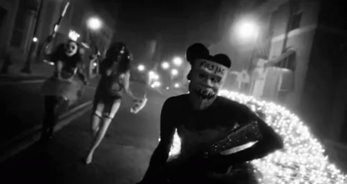 Black And White Photo Of People Wearing Masks GIF