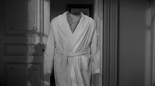 Black and White Photo of Robe Without Head in Doorway