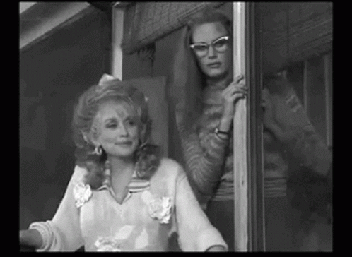 Black and White Photo of Two Women Standing Together