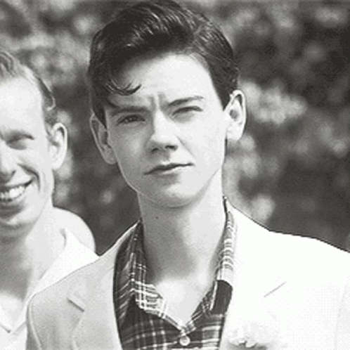 Black And White Photo Of Young Man In Suit Next To Another Man GIF