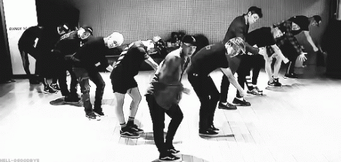 Black and White Photo of Young Men Dancing on Stage