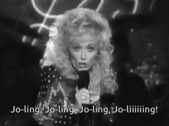 Black and White Photo Woman Holding Microphone Saying Jo-Ling Jo-Ling Jo-Ling Jo-Liiing