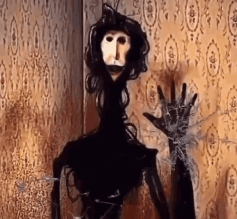 Black and White Puppet in Front of Spider Web