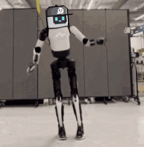 Black and White Robot With Pixelated Face and Hat With Letter X