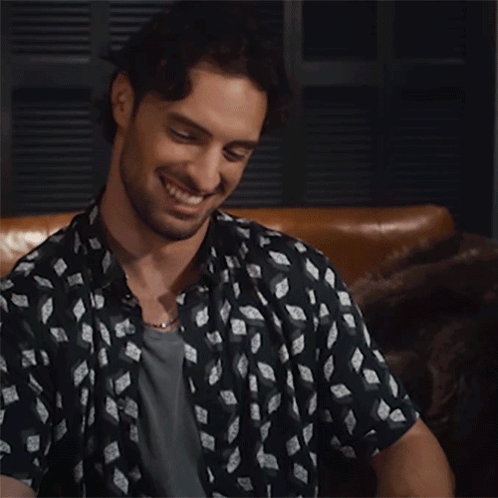 Black and White Shirt Man Smiling on Couch