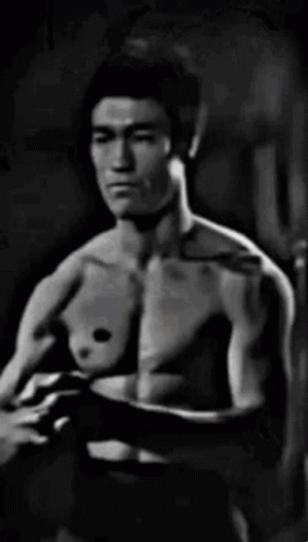 Black And White Shirtless Man In Dark Room GIF
