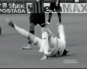 Black and White Soccer Player Falling on Field
