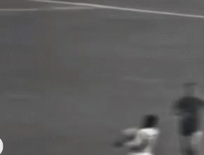 Black And White Soccer Player Kicking Ball GIF