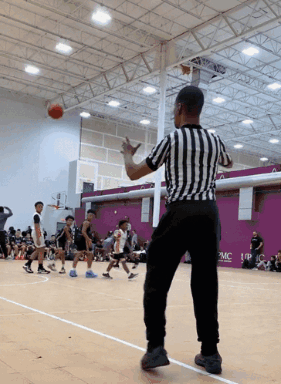Black and White Striped Referee Watching Basketball