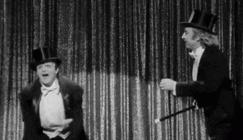 Black And White Two Men In Top Hats And Tuxedos On Stage GIF
