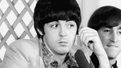 Black And White Two Men Sitting One Looking At Camera GIF
