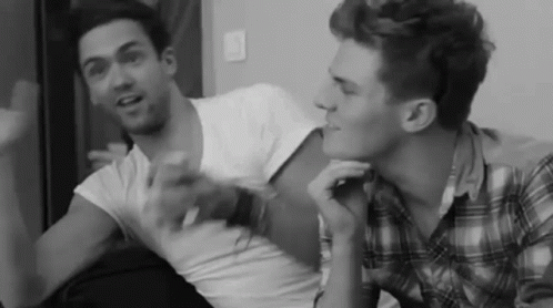 Black and White Two Men Talking on Couch