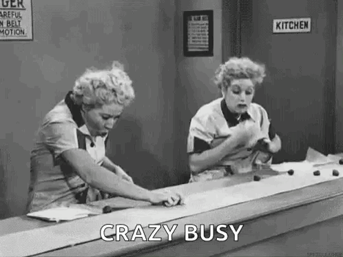 Black and White Two Women at Counter Saying Crazy Busy