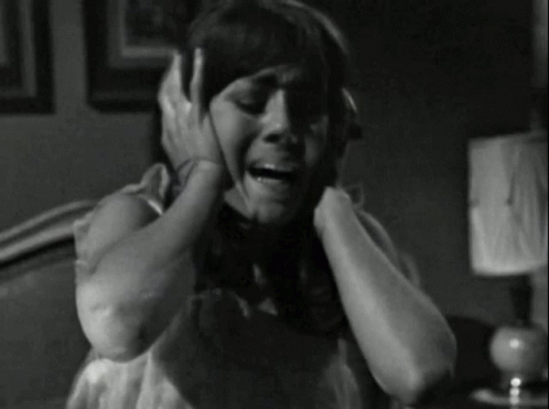 Black and White Woman Covering Ears