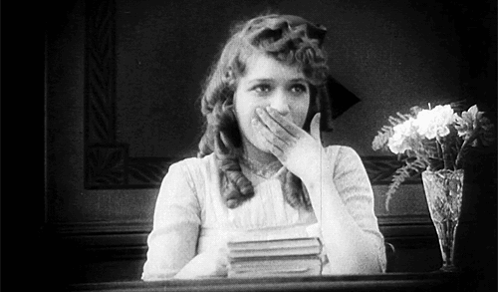 Black and White Woman Covering Mouth