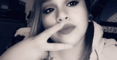 Black and White Woman Covering Mouth with Finger