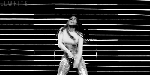 Black And White Woman Dancing In Front Of Wall With Lights GIF
