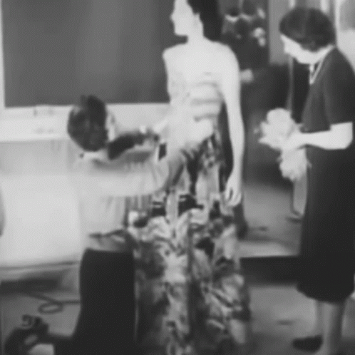 Black and White Woman Having Dress Adjusted