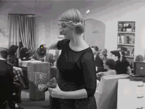 Black And White Woman Holding Bottle With Letter O GIF