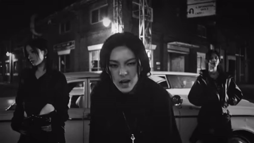 Black And White Woman In Front Of Car GIF